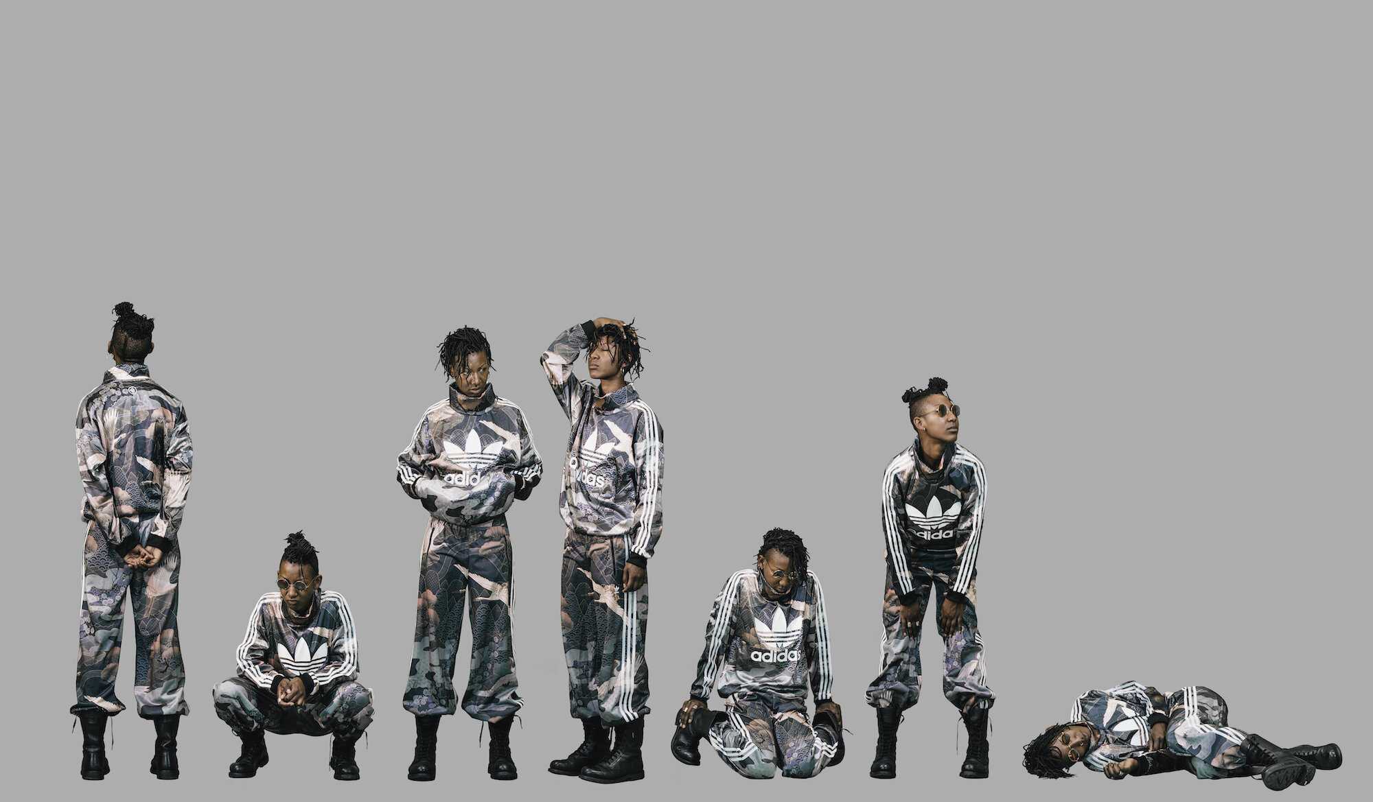 A grey backdrop with seven images of a person added at the bottom part of the picture. In each of the pictures the person has a different pose but is wearing the same adidas track suit.